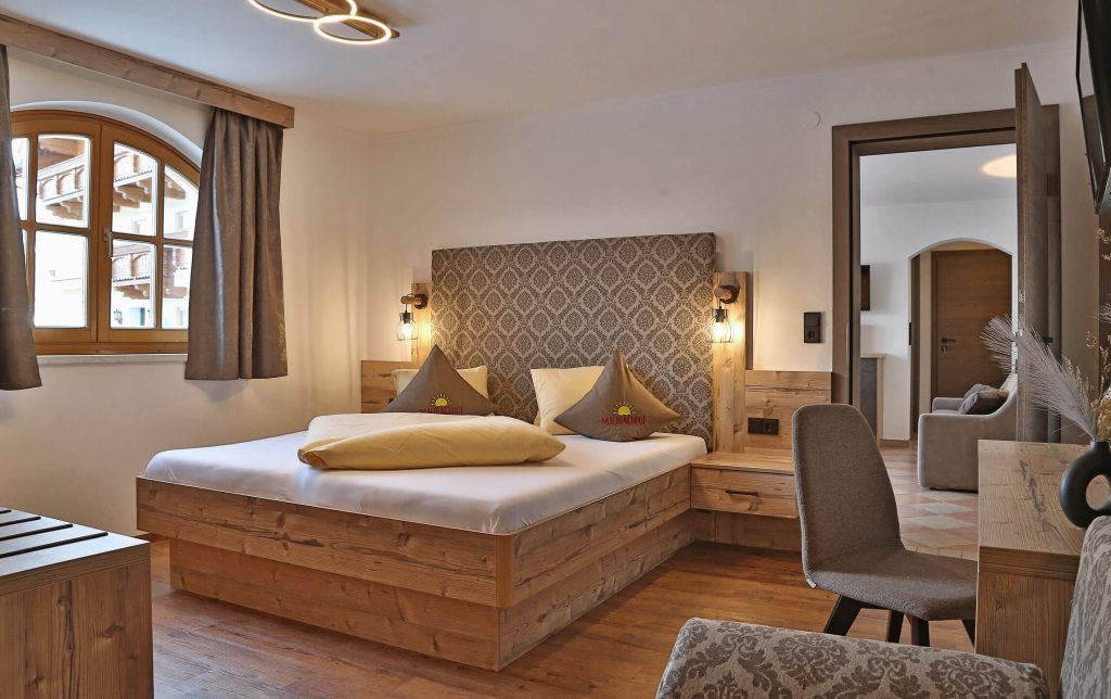 Cozy room at Maurachhof with wood design, window view, and comfortable furnishings.